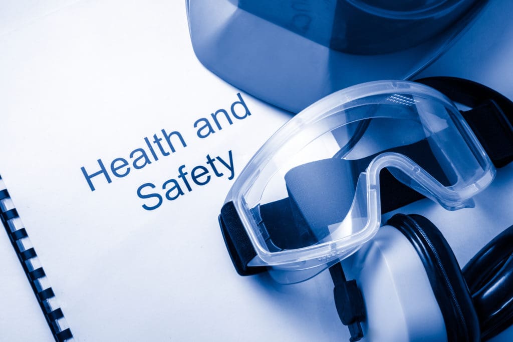 Booklet titled Heath and safety under a pair of protective goggles.