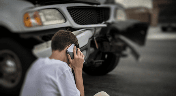 person using phone after accident