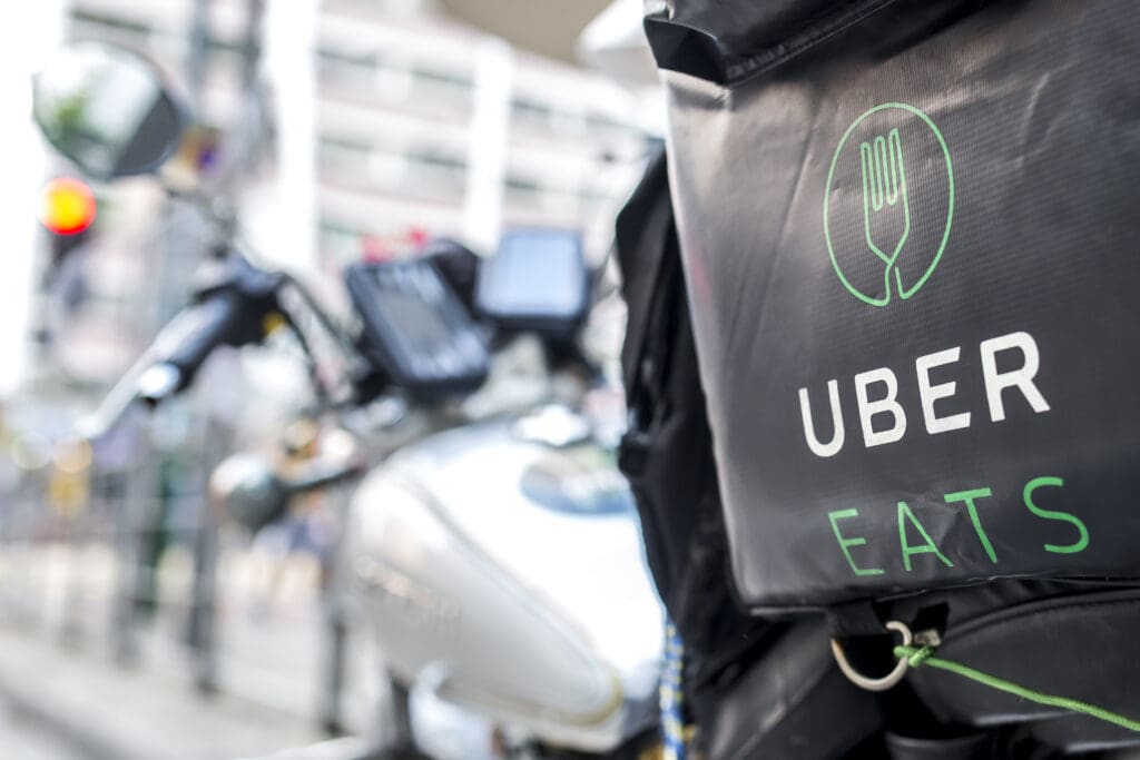 close up of a bag with a green fork on it and the title uber eats