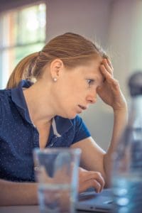 stressed woman trying to figured out how to handle her own slip and fall case